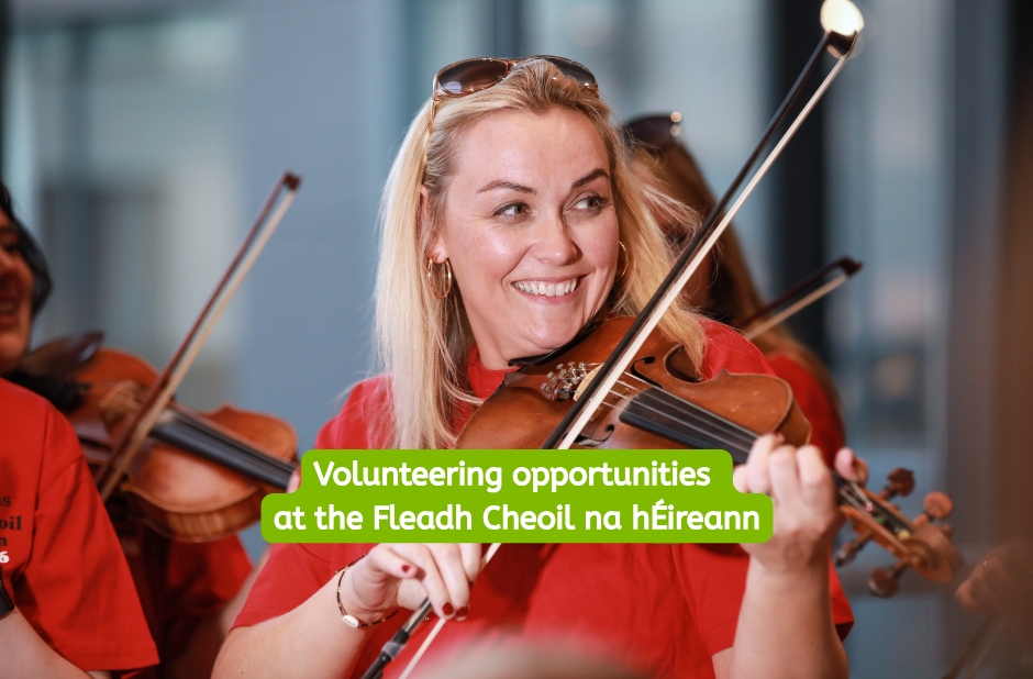 A smiling girl with sunglasses on top of her head playing the fiddle